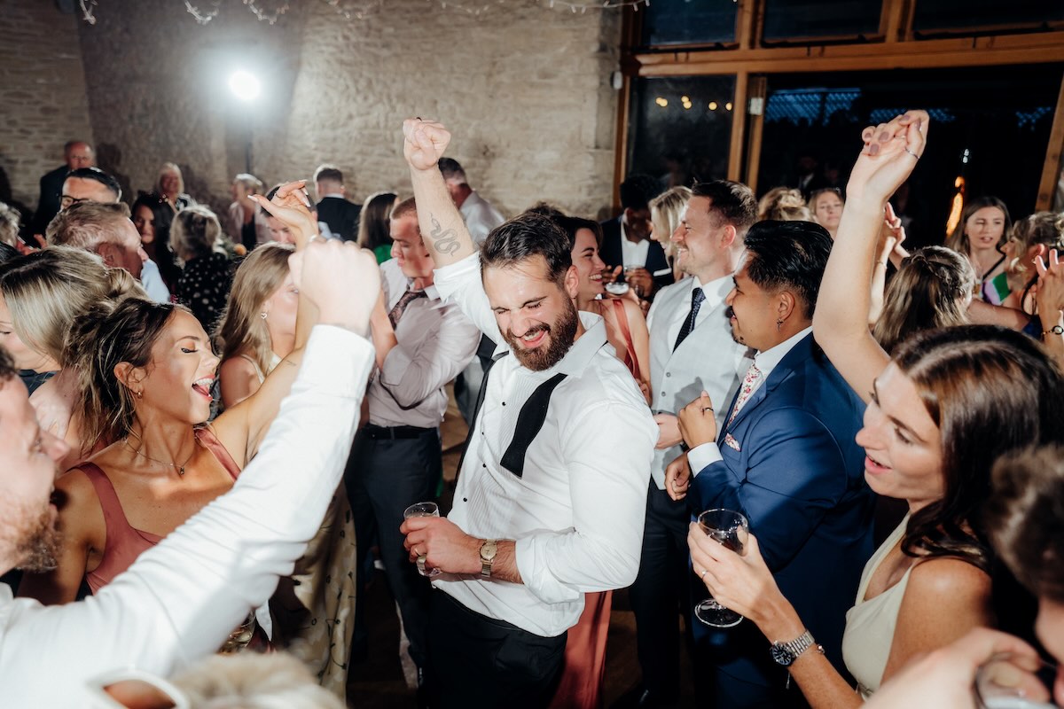 Wedding guests dancing during a Kingscote Barn evening reception