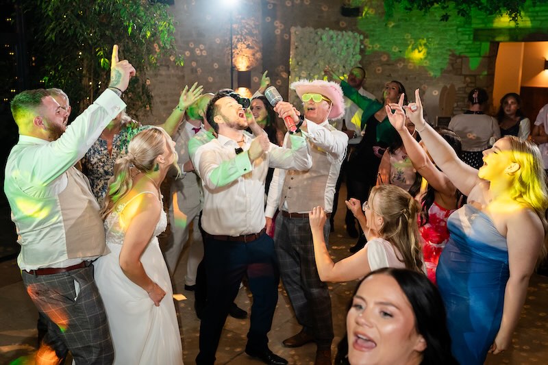 Crowd enjoying a Cotswolds wedding DJ set at Old Gore Barn