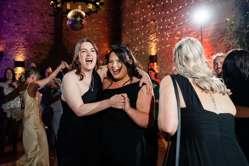 Guests enjoying the evening party at Stone Barn wedding venue