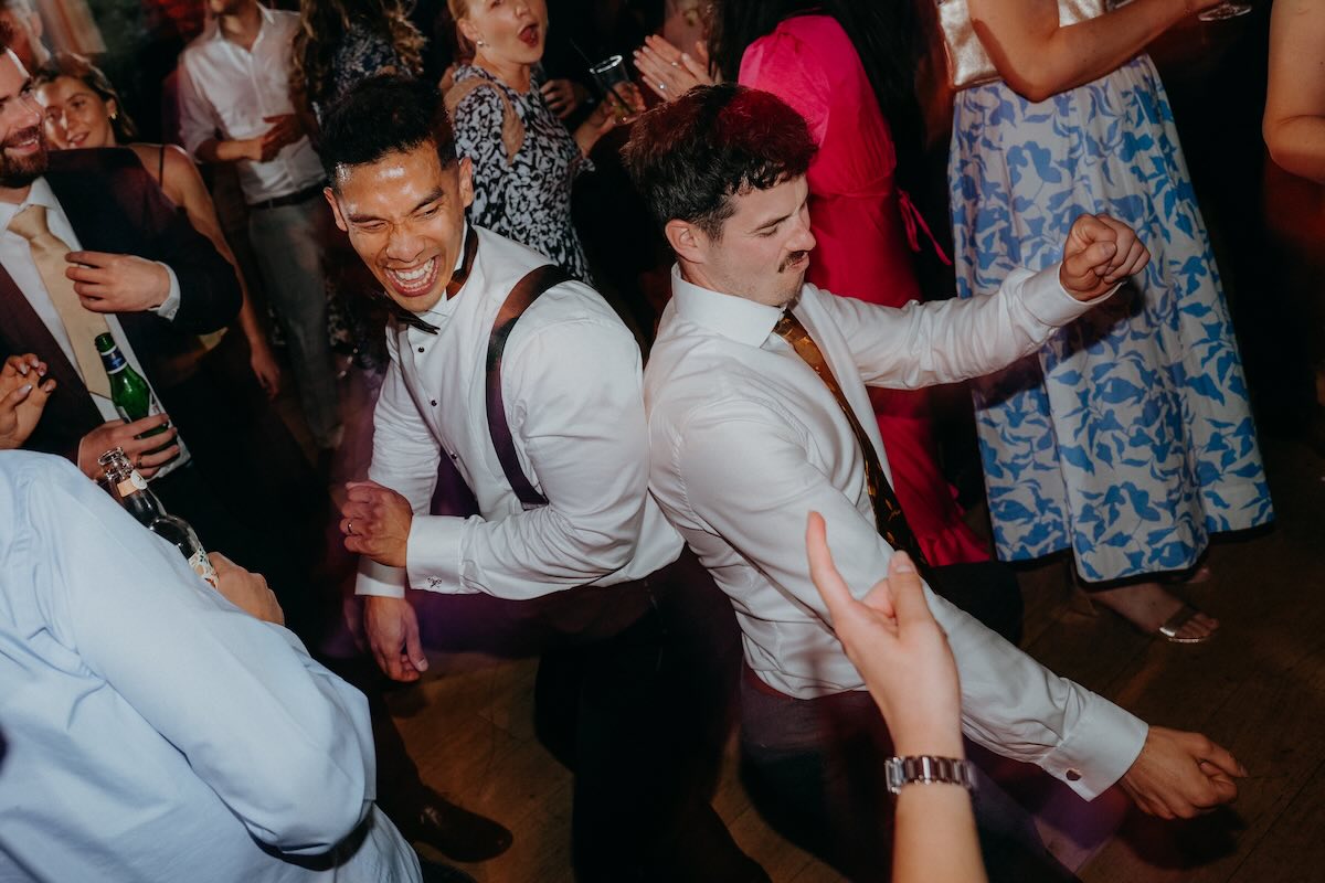 Wedding guests dancing together at Hyde House