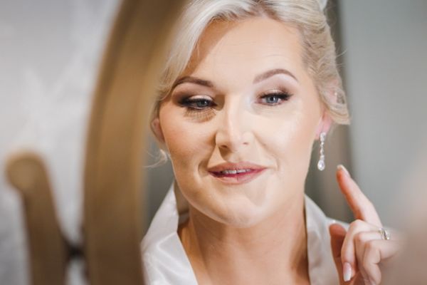 Close up of bride during makeup preparation on her wedding morning